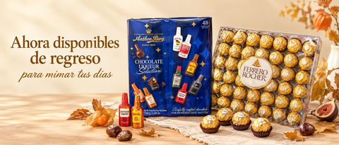 Cajas de Anthon Berg y Ferrero Rocher sobre madera clara con hojas de otono. Ahora disponibles de regreso para mimar tus dias.